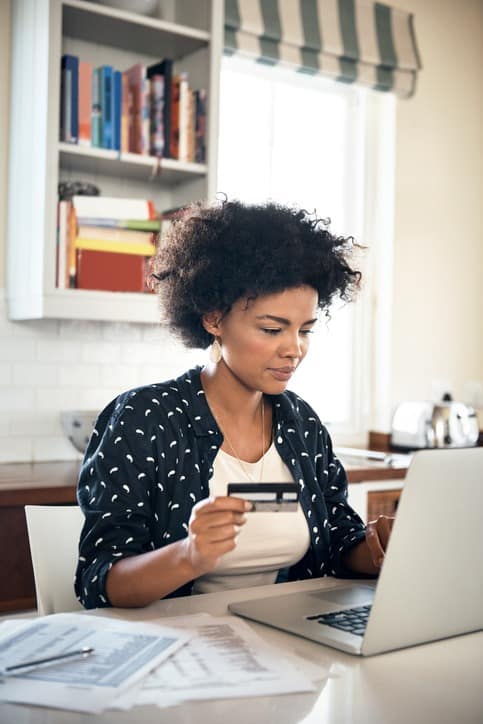 Young woman paying bills online