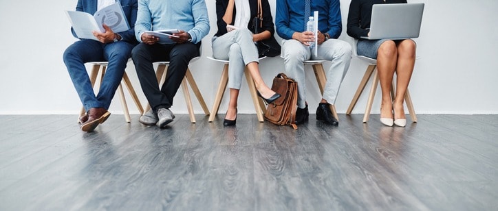 Cropped studio shot of a group of diverse businesspeople waiting in line