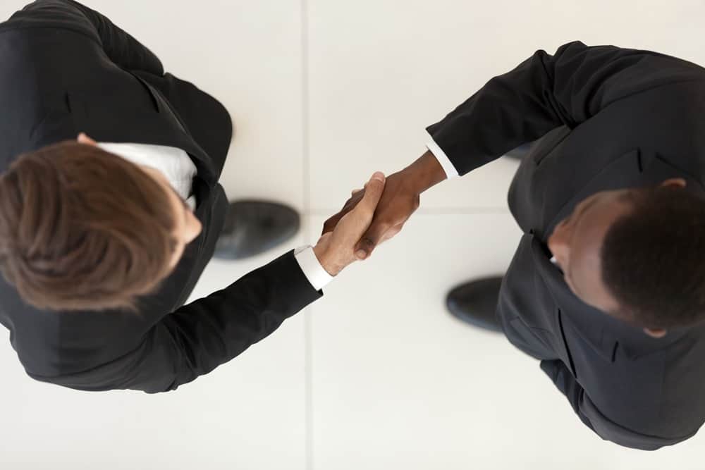 Two business men shaking hands,