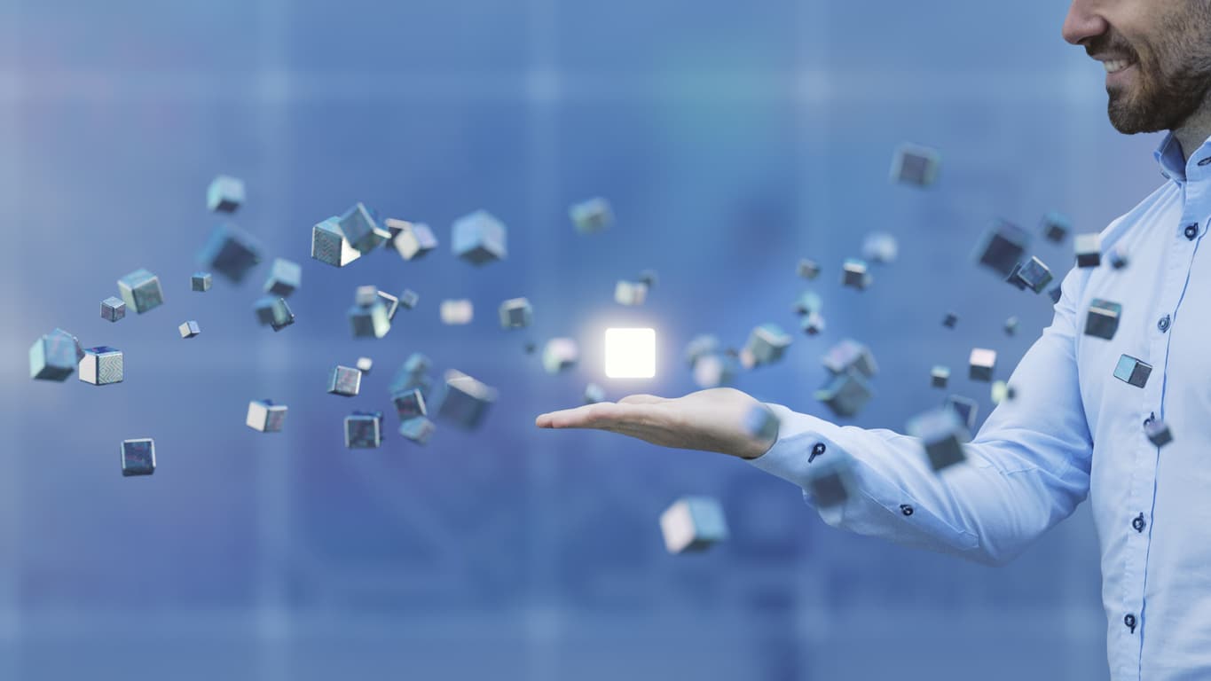 Businessman with flying cubes